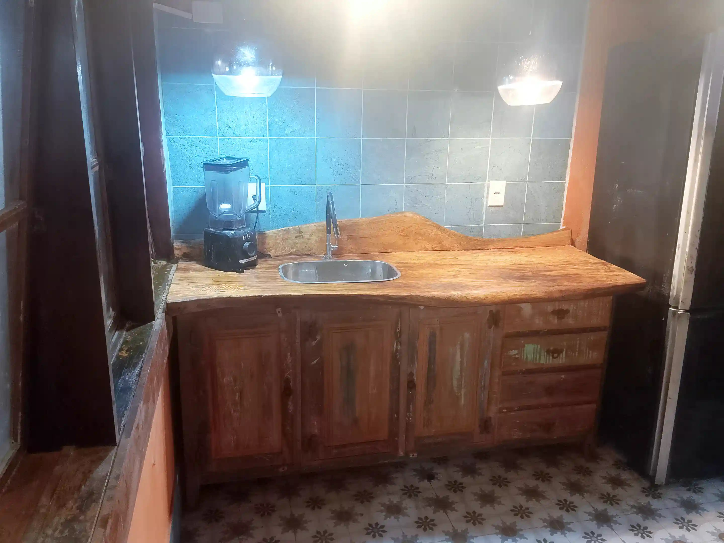 Kitchen cabinet is of demolition wood with exotic,hardwood counters