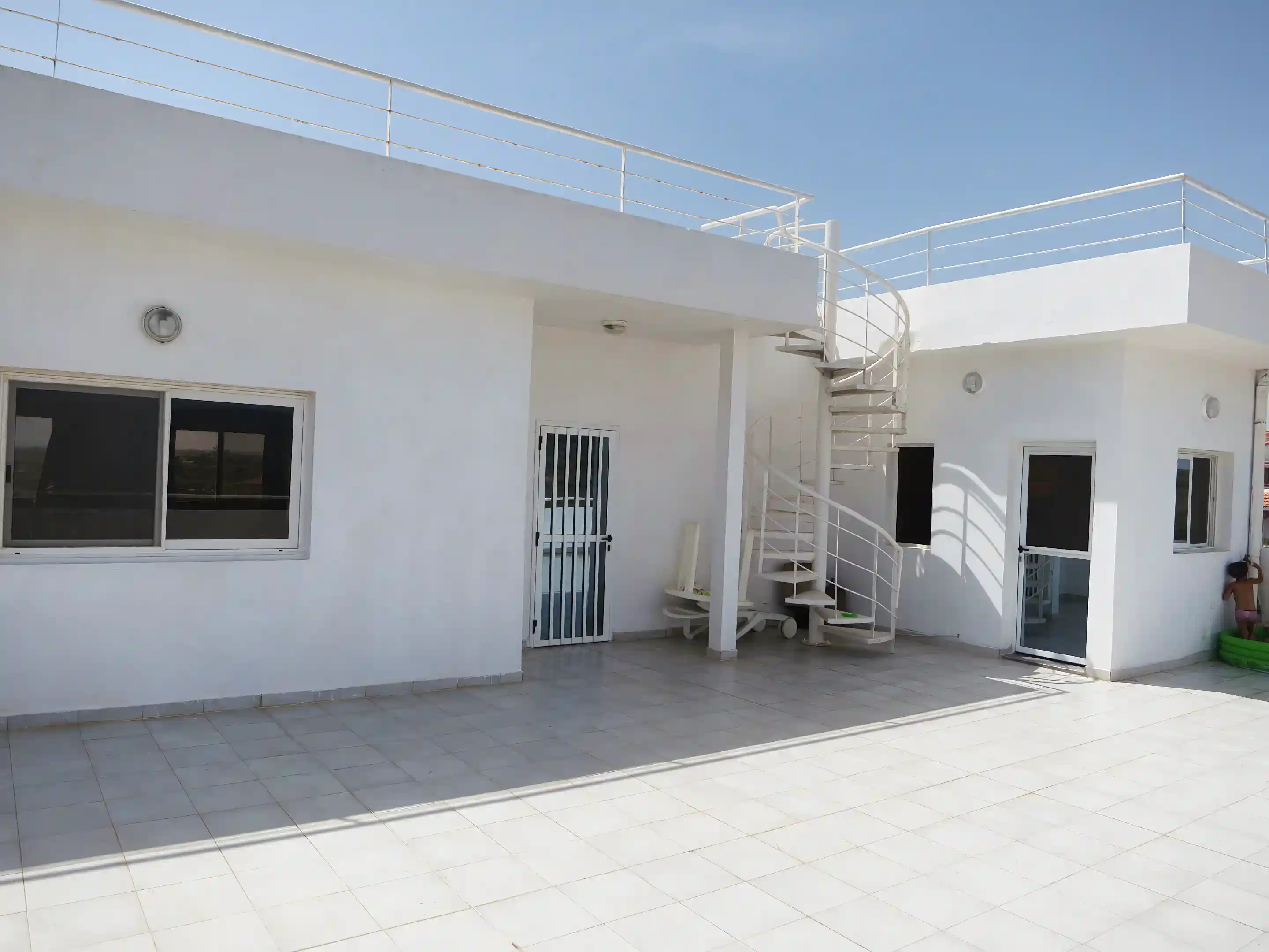 Entrances to second floor and external kitchen with staircase to...