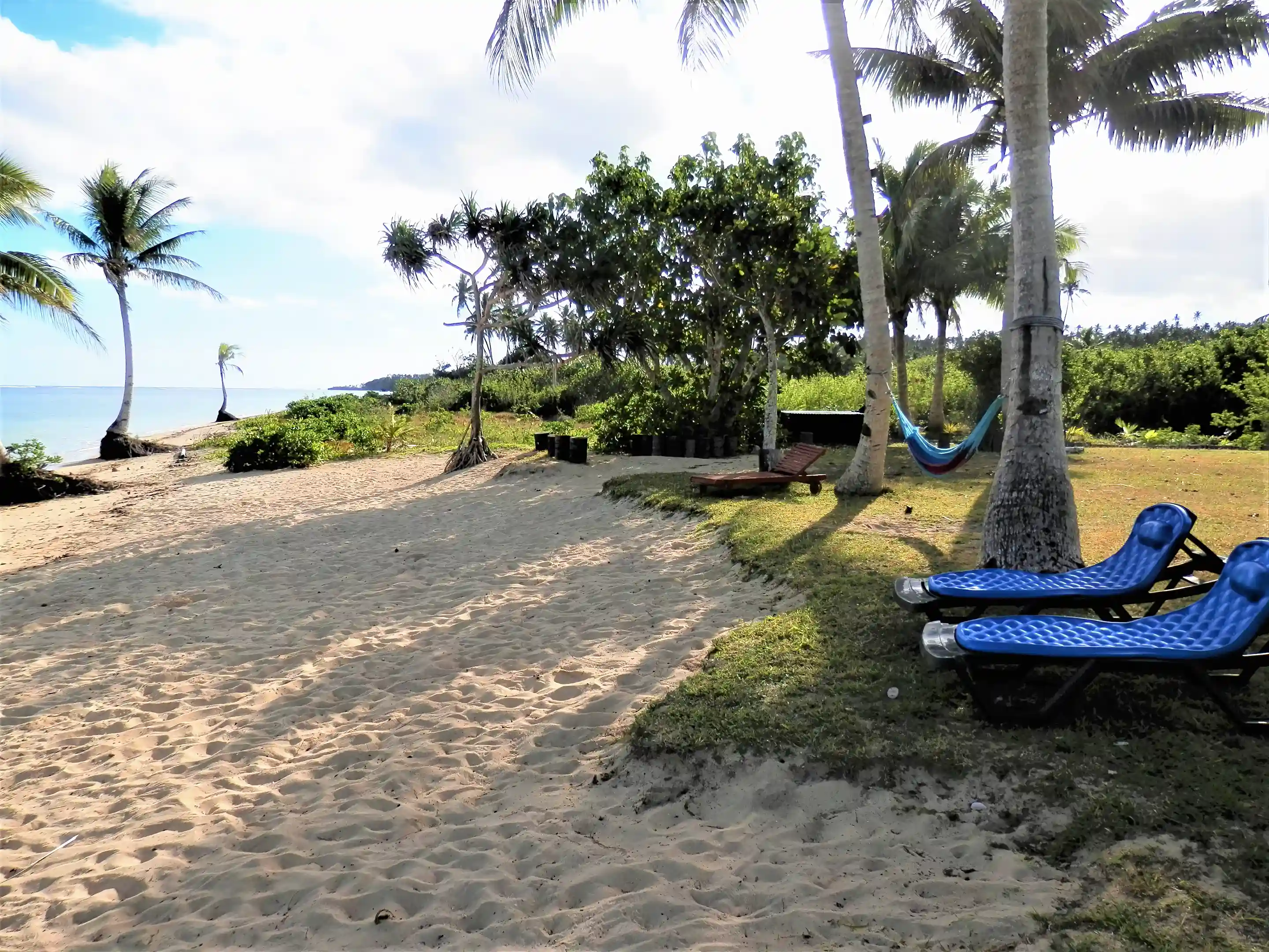 Here is one of three beach lounge areas, two with...