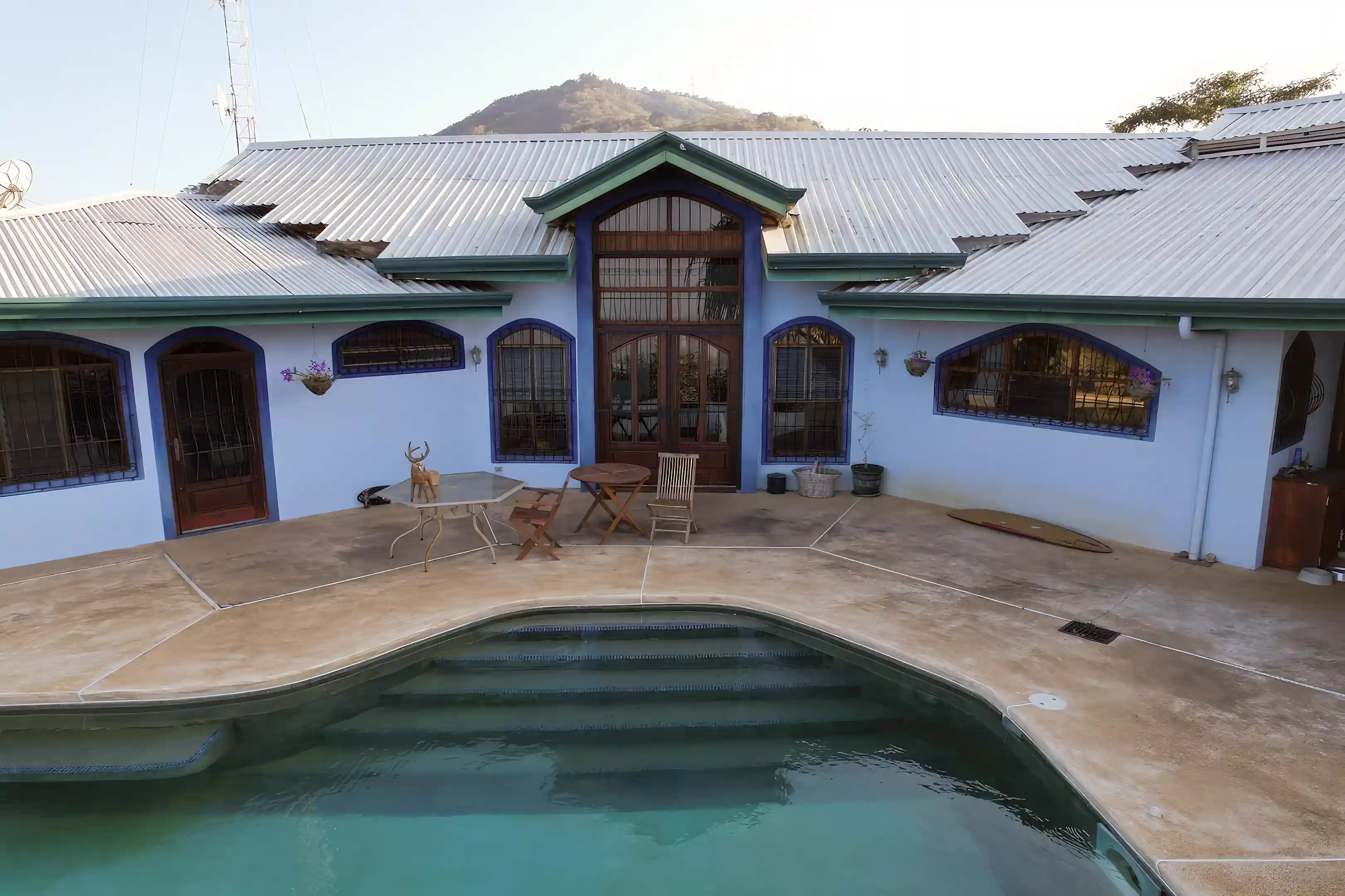 partial view of front of house with pool