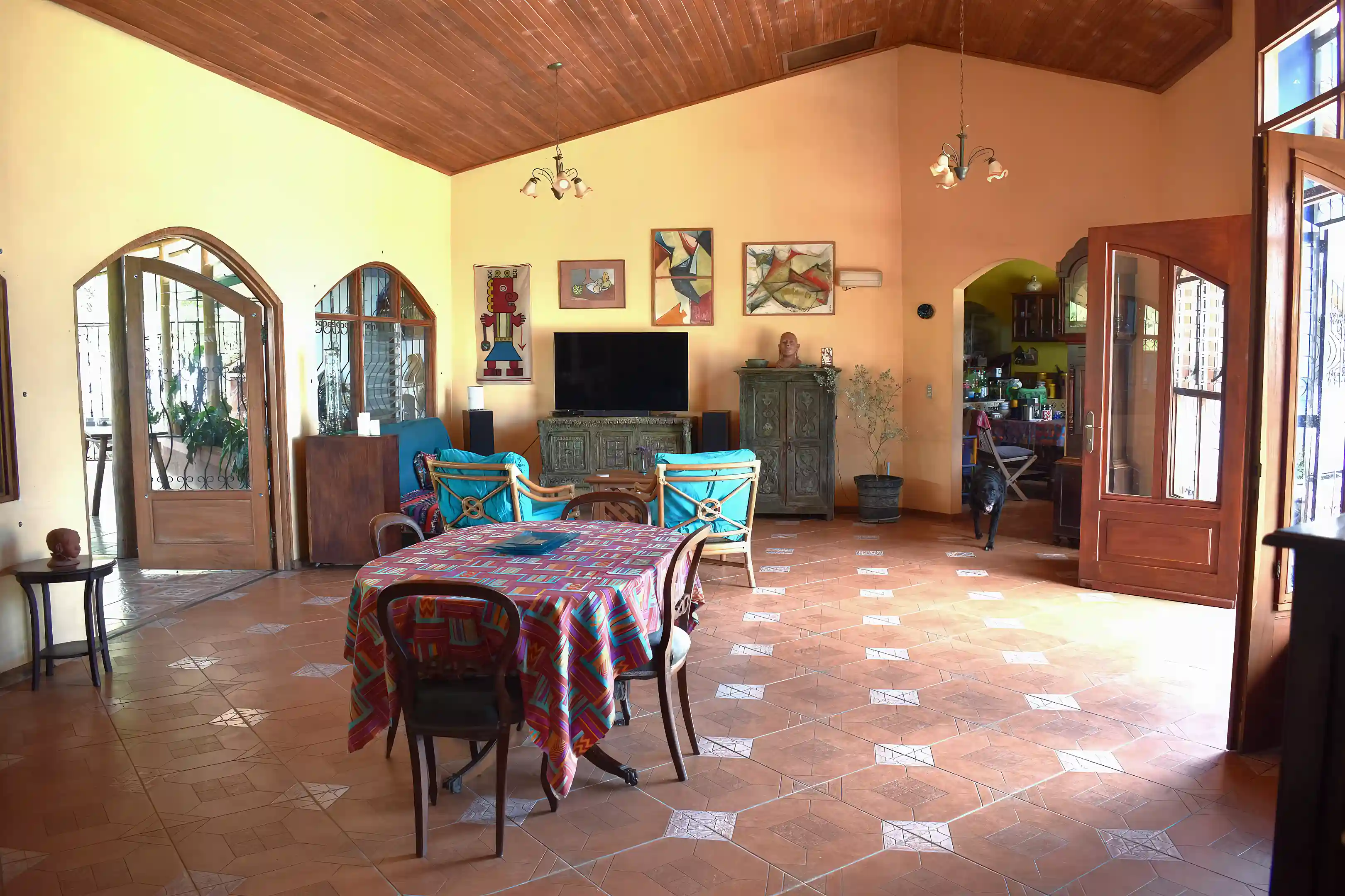 sala. terrace to left, pool to right, opening to kitchen