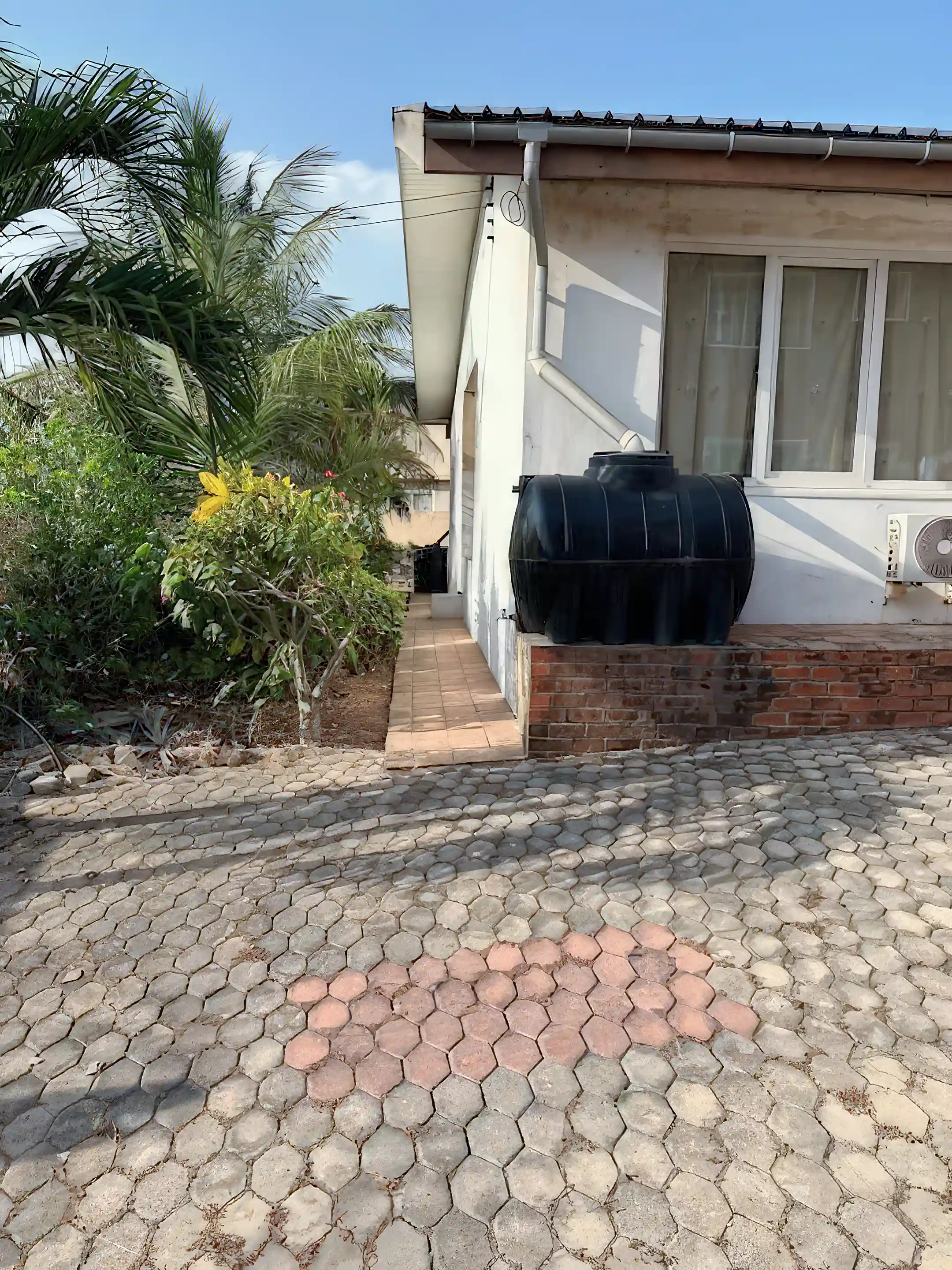 Mature garden and multiple water tanks