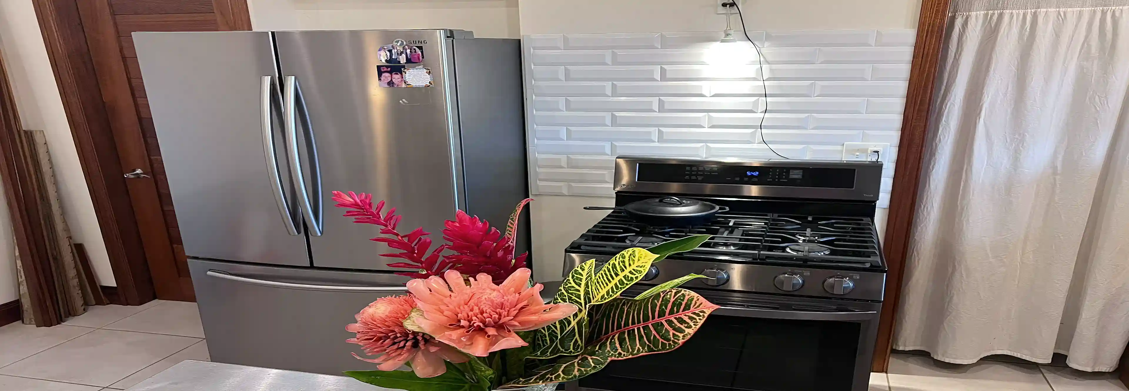 Straight-on view of the kitchen highlighting a Samsung dual-door refrigerator...