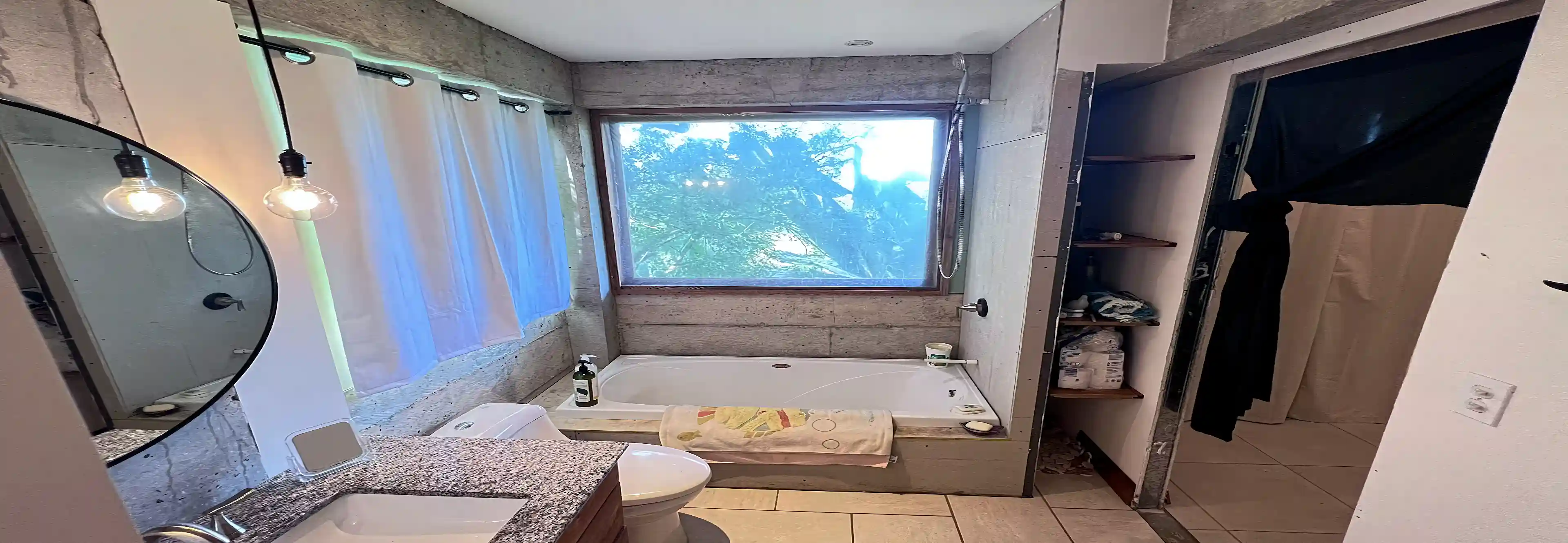 Viewed from the laundry, this bathroom mirrors the style of...