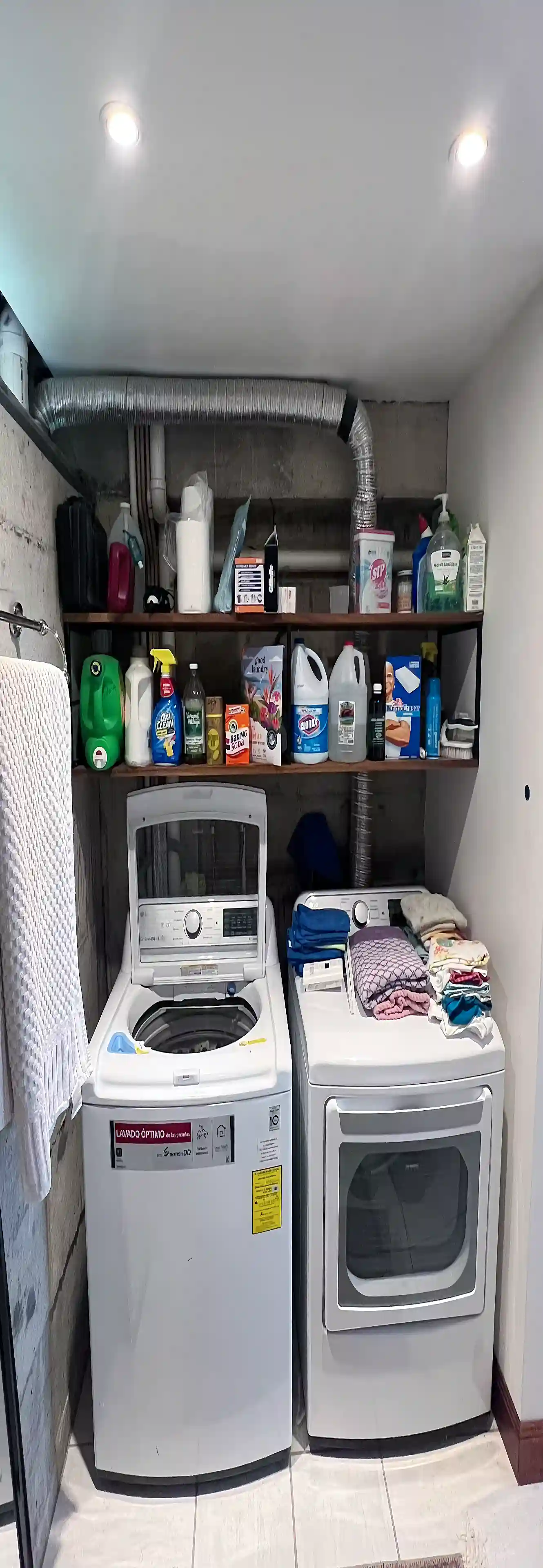 Laundry area with LG Smart washer and dryer, plus overhead...