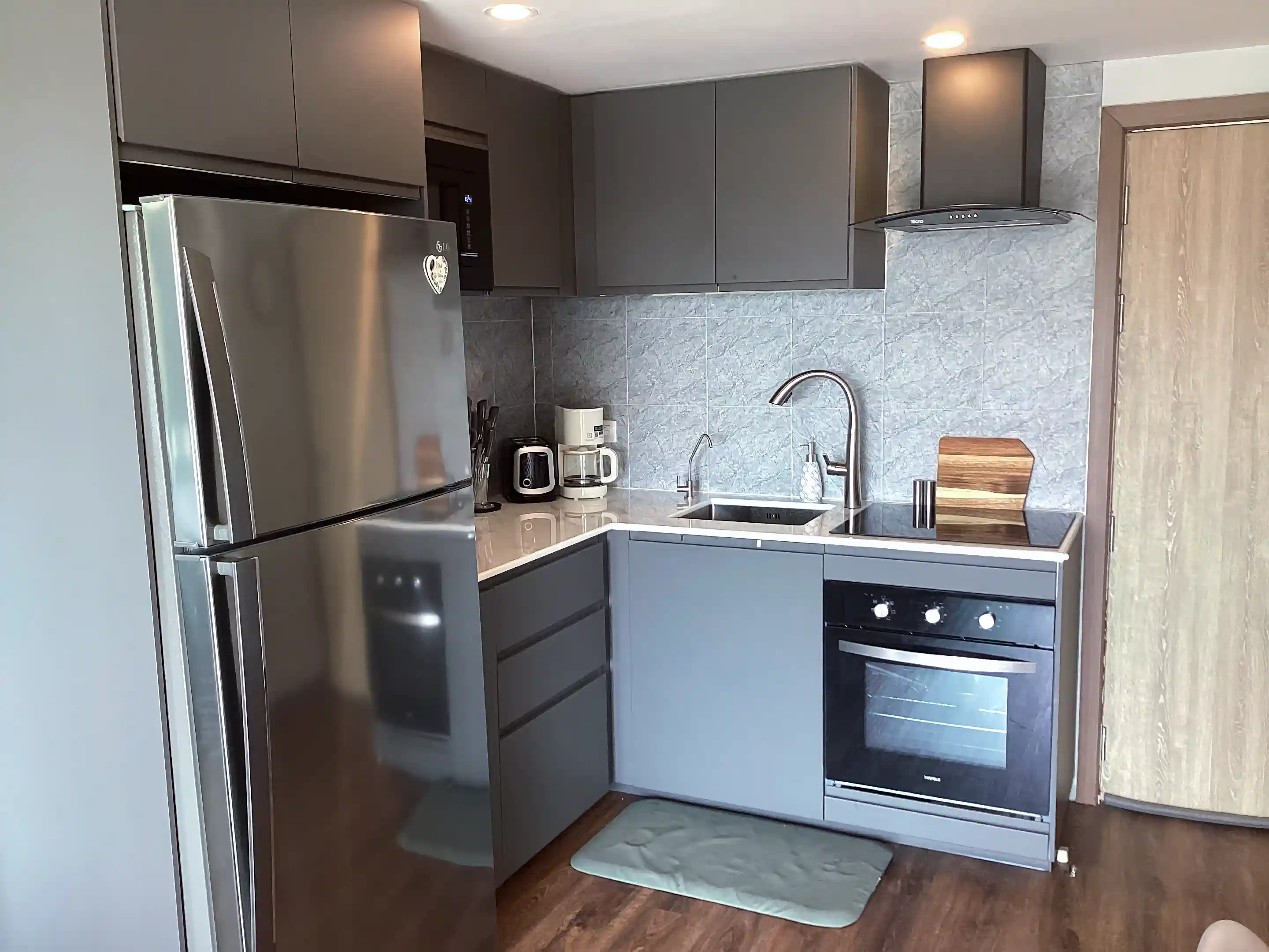 Full kitchen including oven/cooktop/vent/microwave/refrigerator