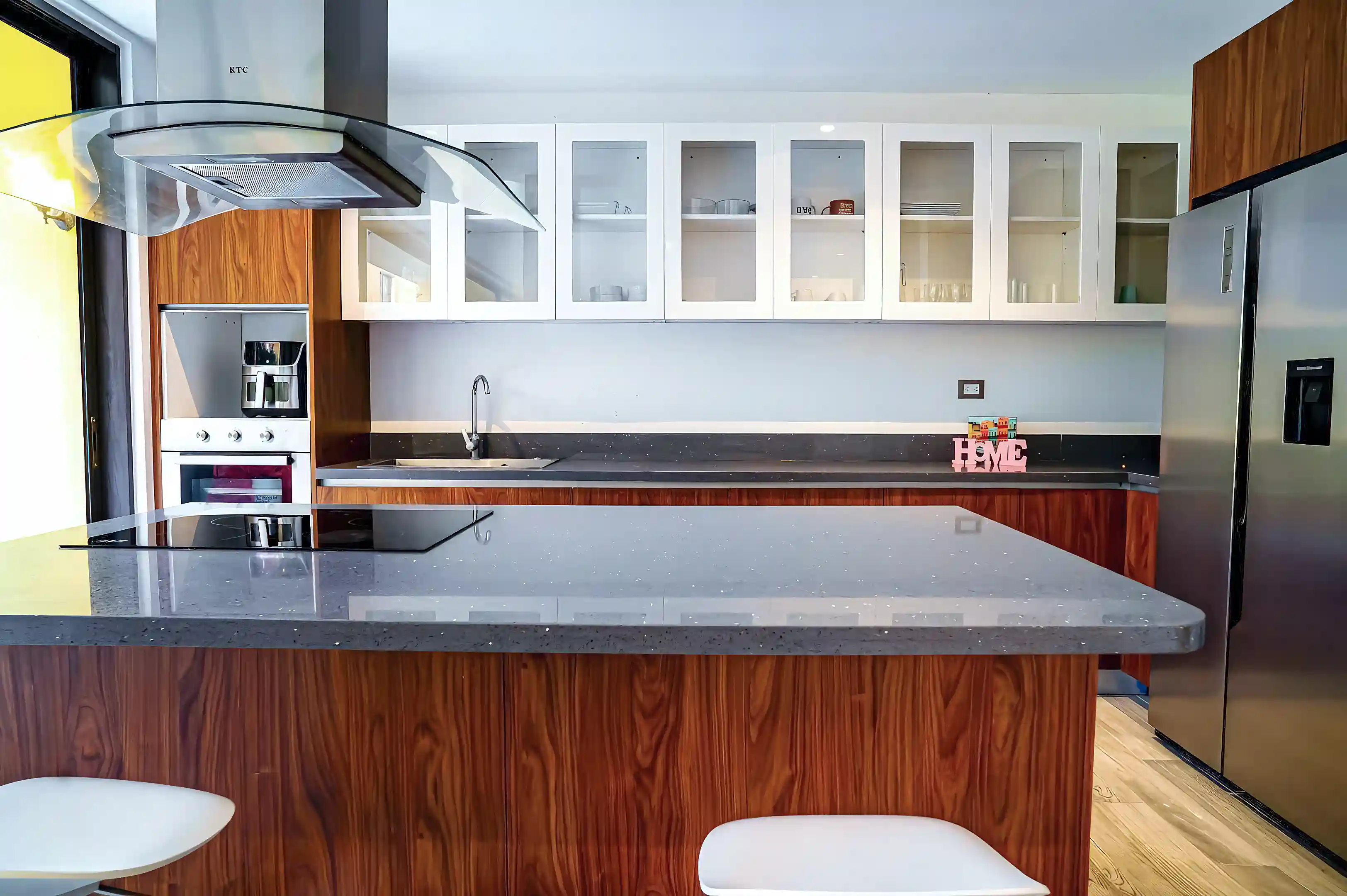 Modern open-concept kitchen featuring a sleek design with high-quality finishes....