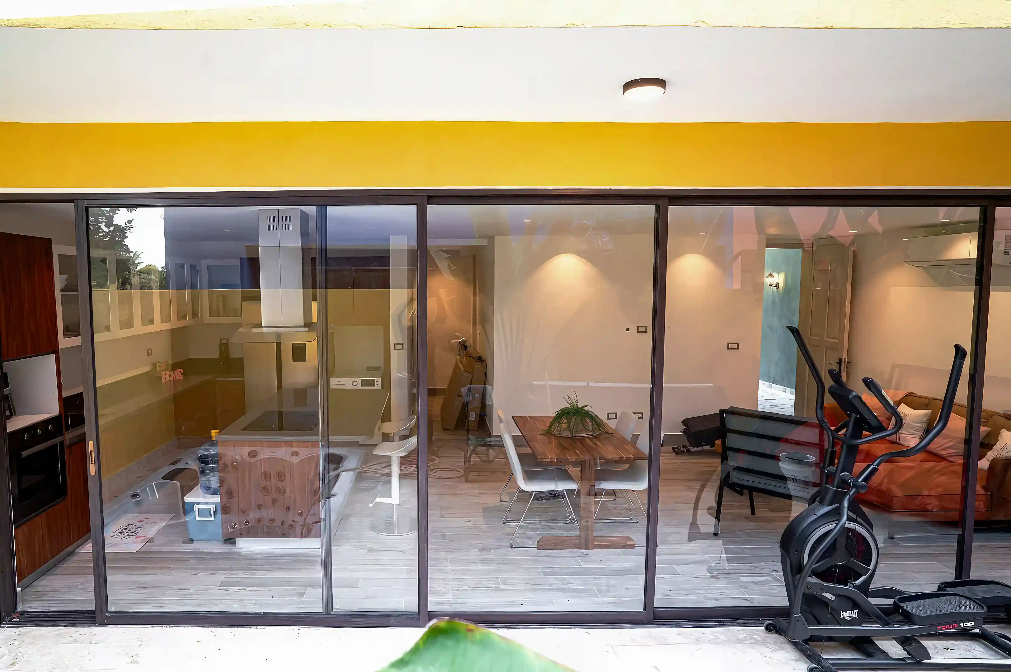 Full-width sliding glass doors create a seamless connection between the...