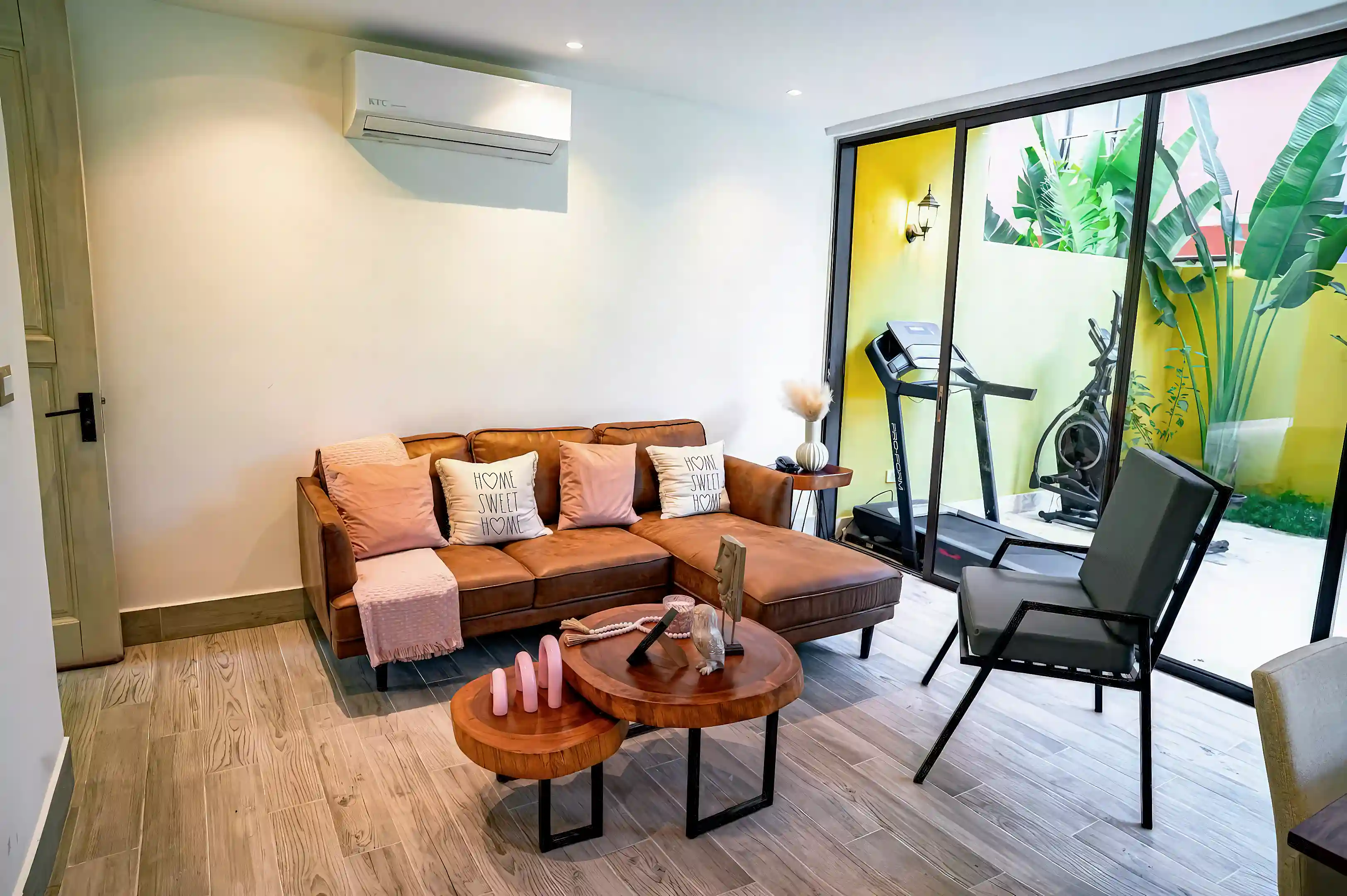 Bright and modern living area featuring a comfortable L-shaped leather...