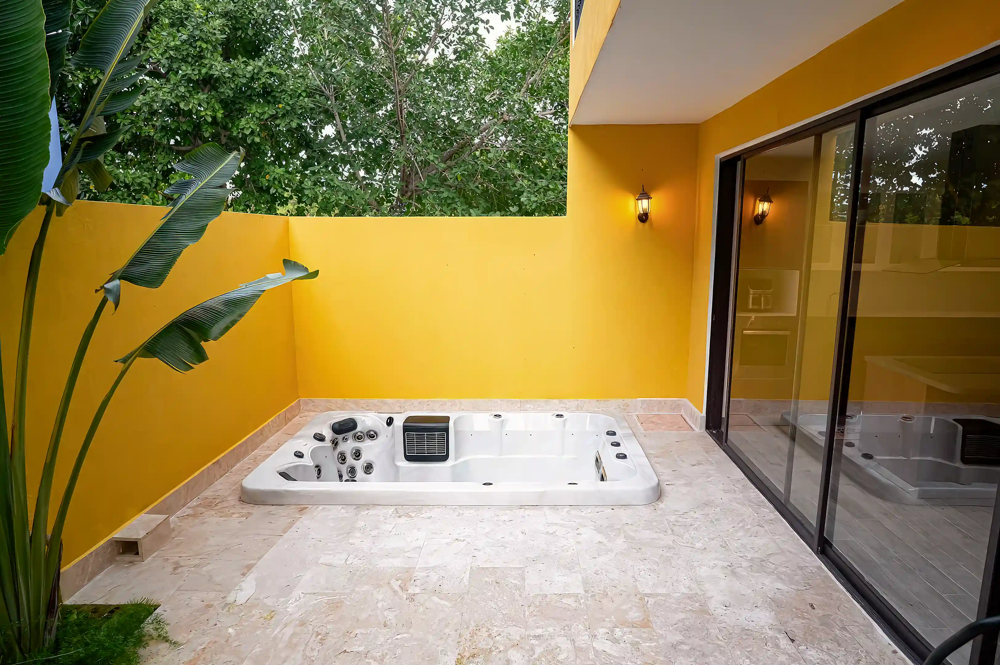 Private outdoor terrace featuring a built-in jacuzzi, offering a relaxing...