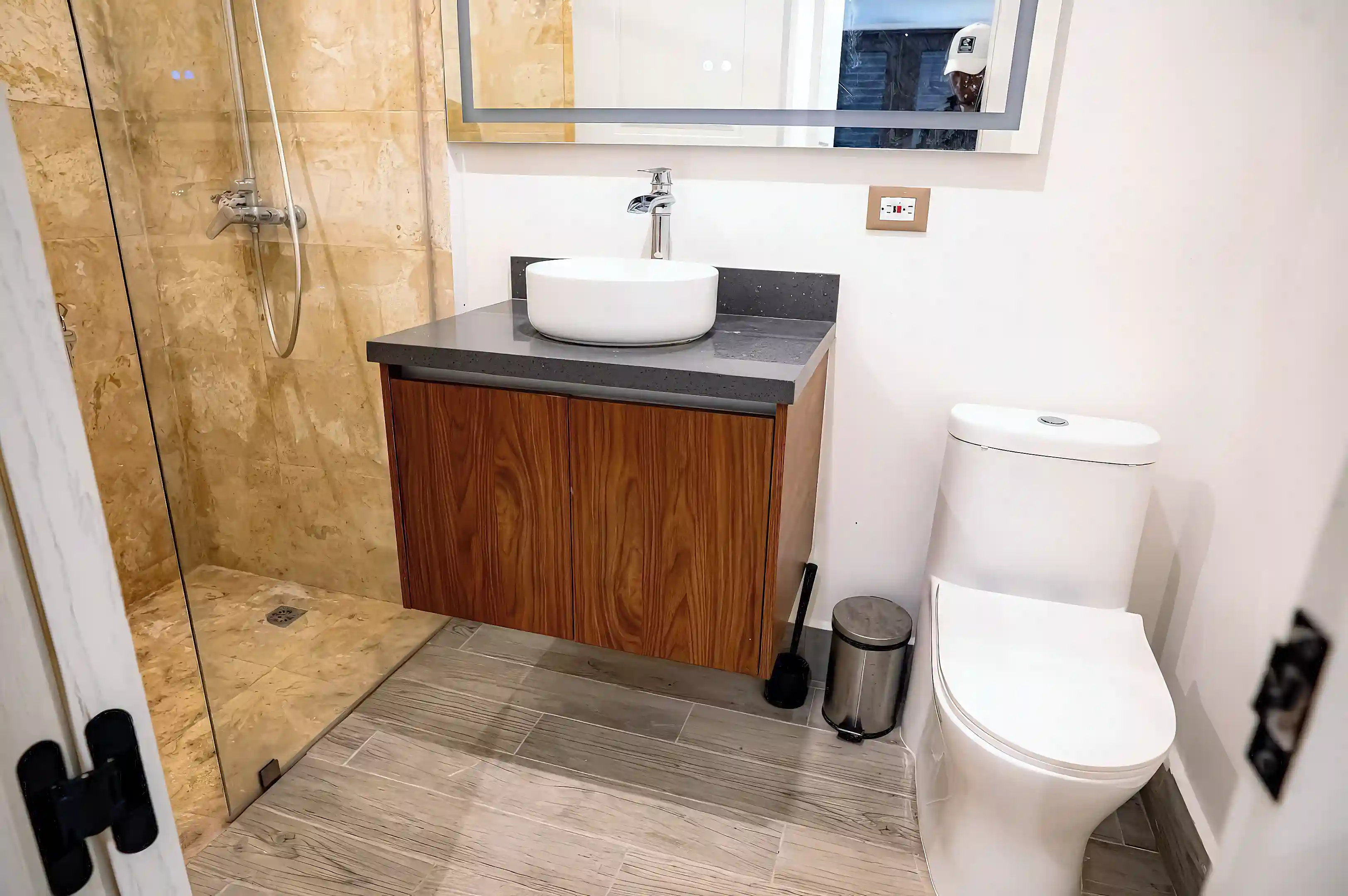 Modern bathroom featuring a sleek, floating vanity with a stone...