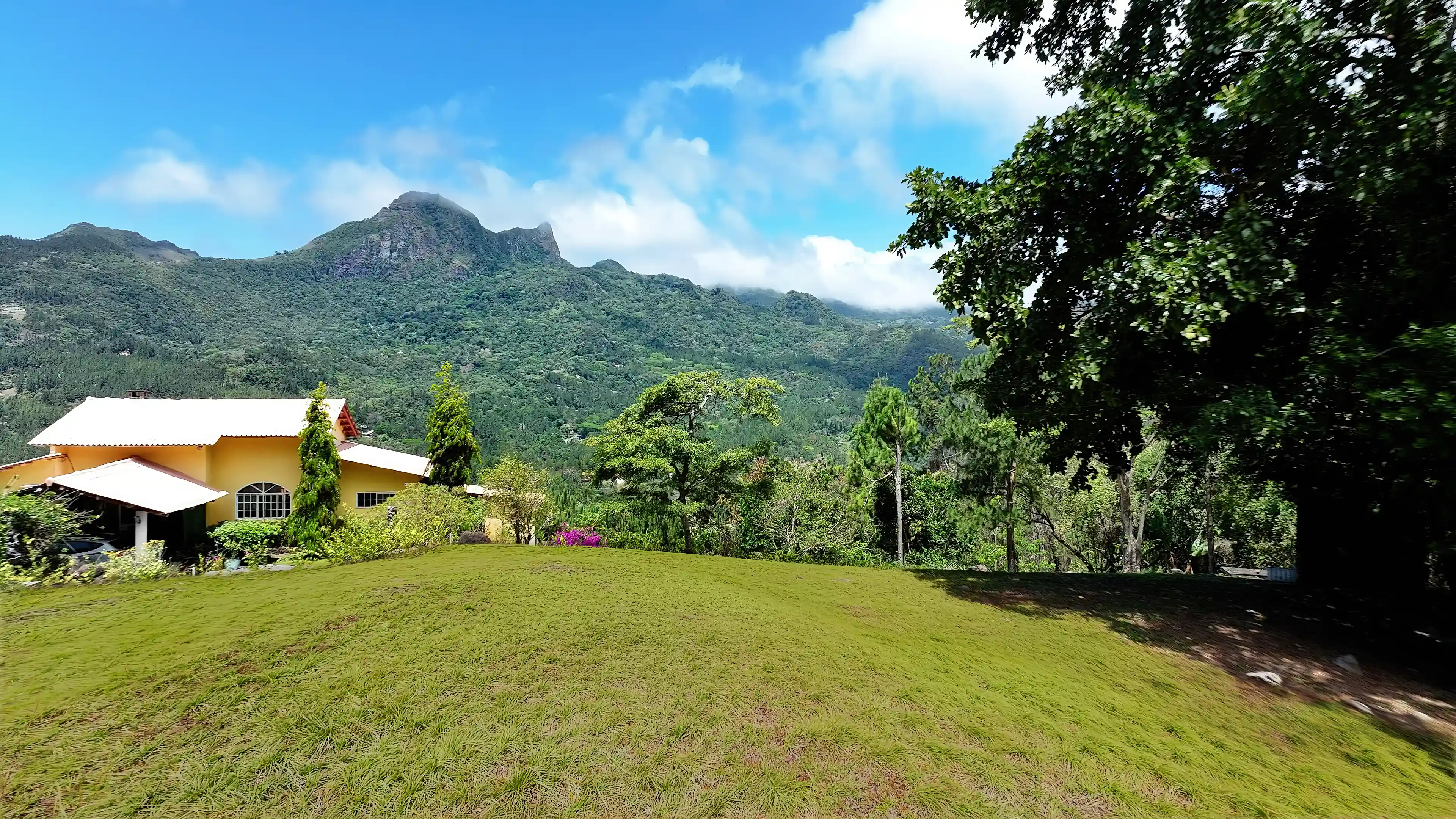 Spectacular mountain views visible from the lot. The open green...