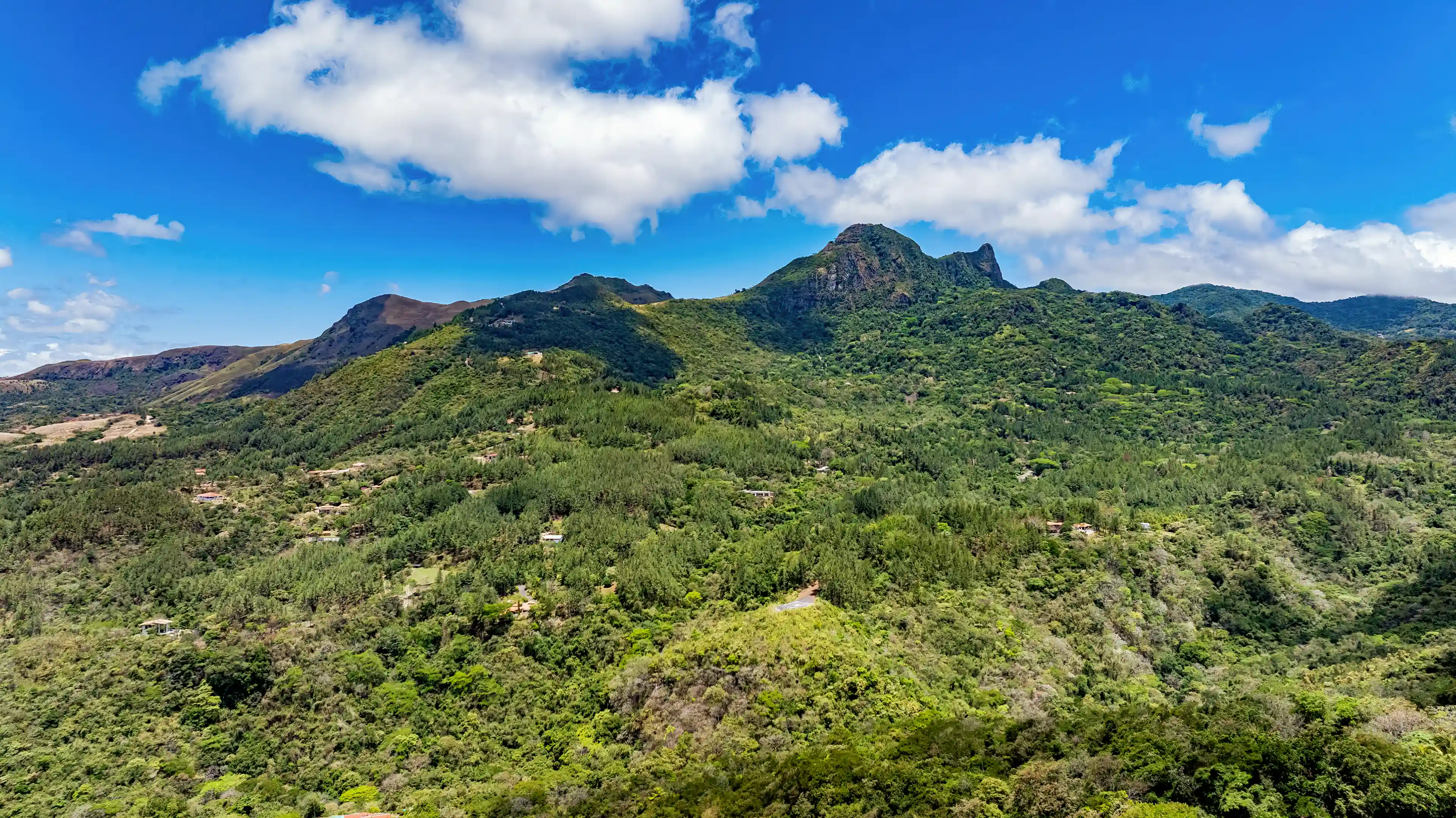 Panoramic view of the surrounding mountains and lush valley visible...