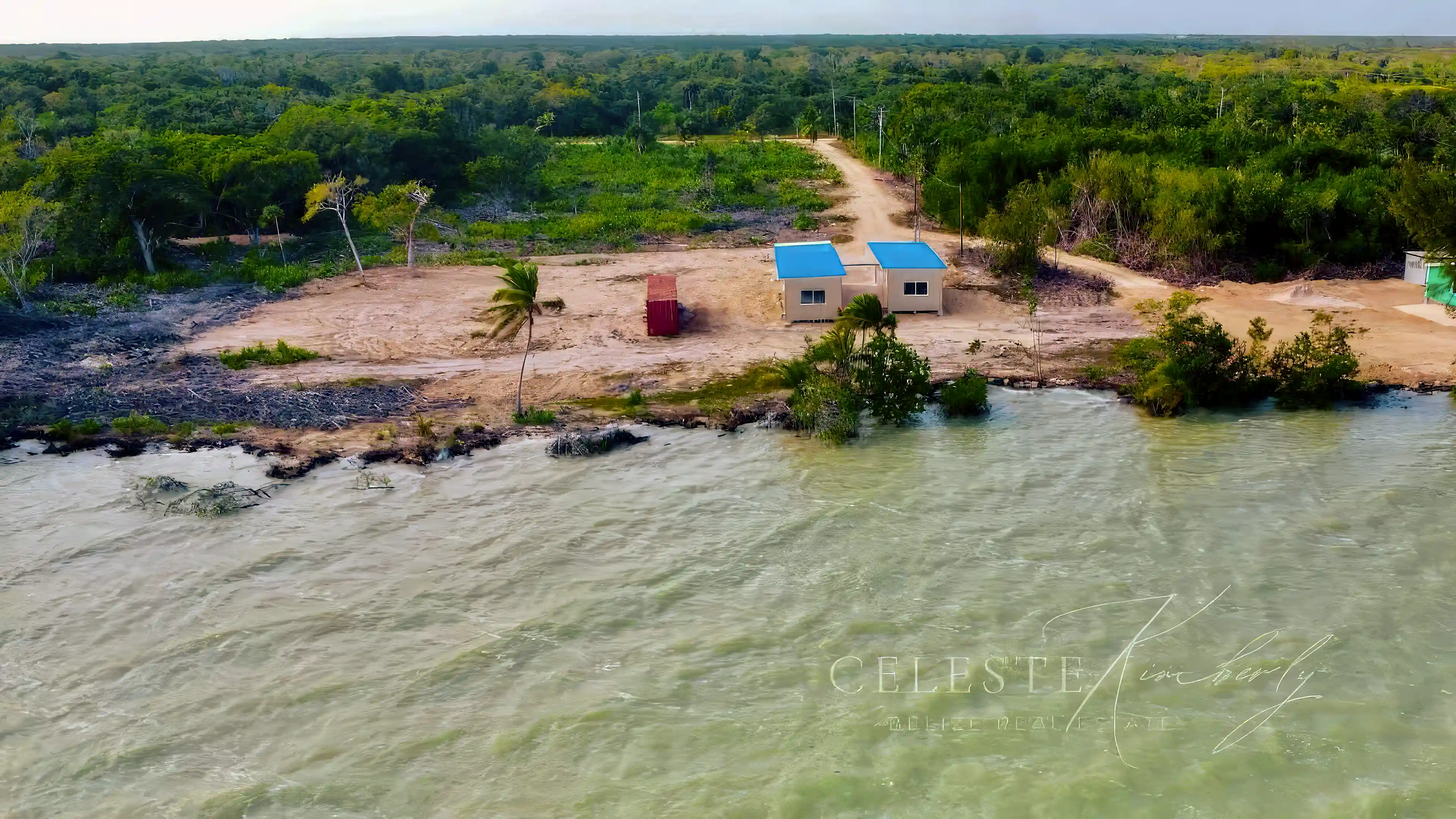 View from the water towards the house (and container with...
