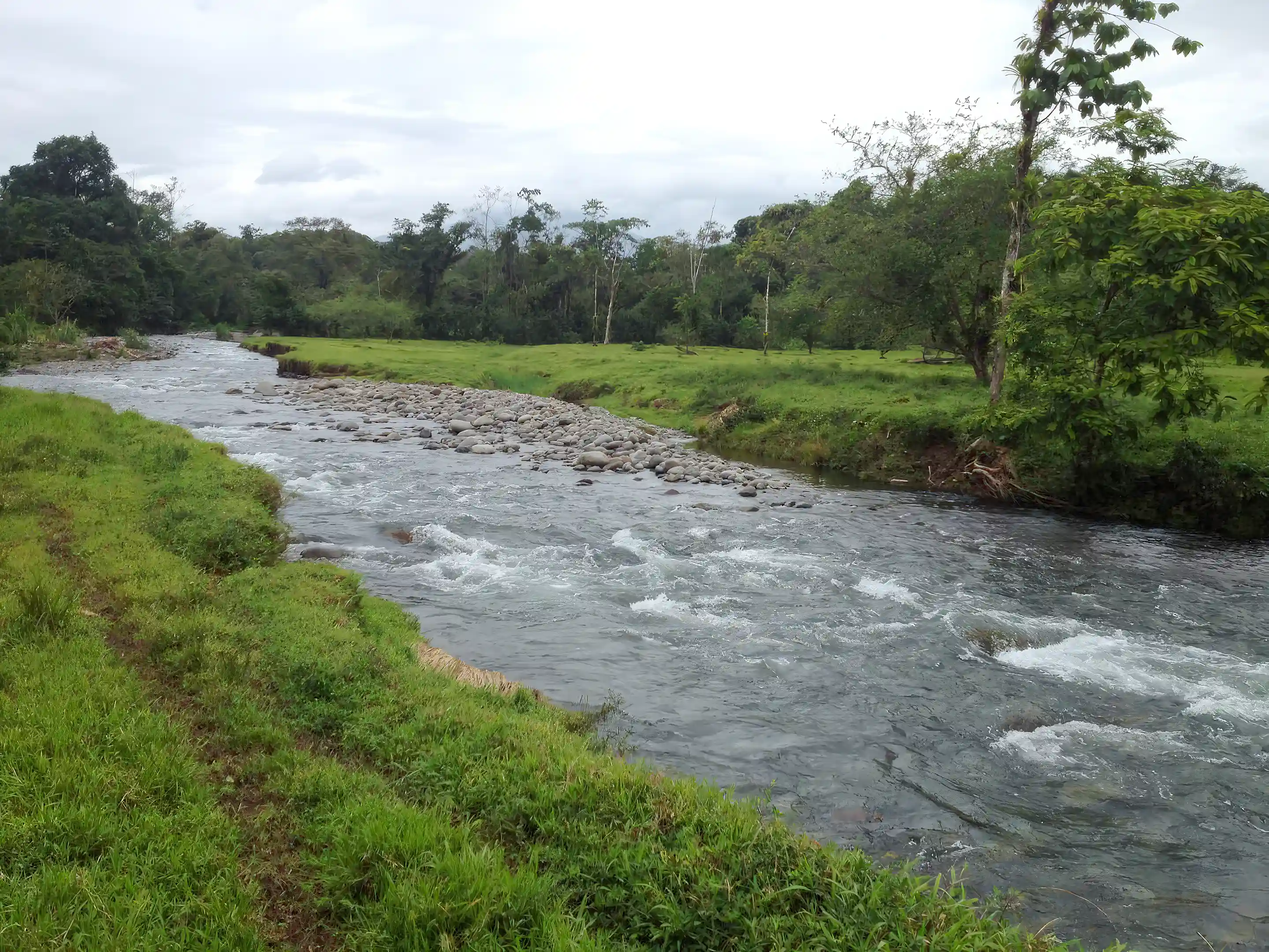 Natural river crossing Hacienda Santa María, with clear flowing water,...