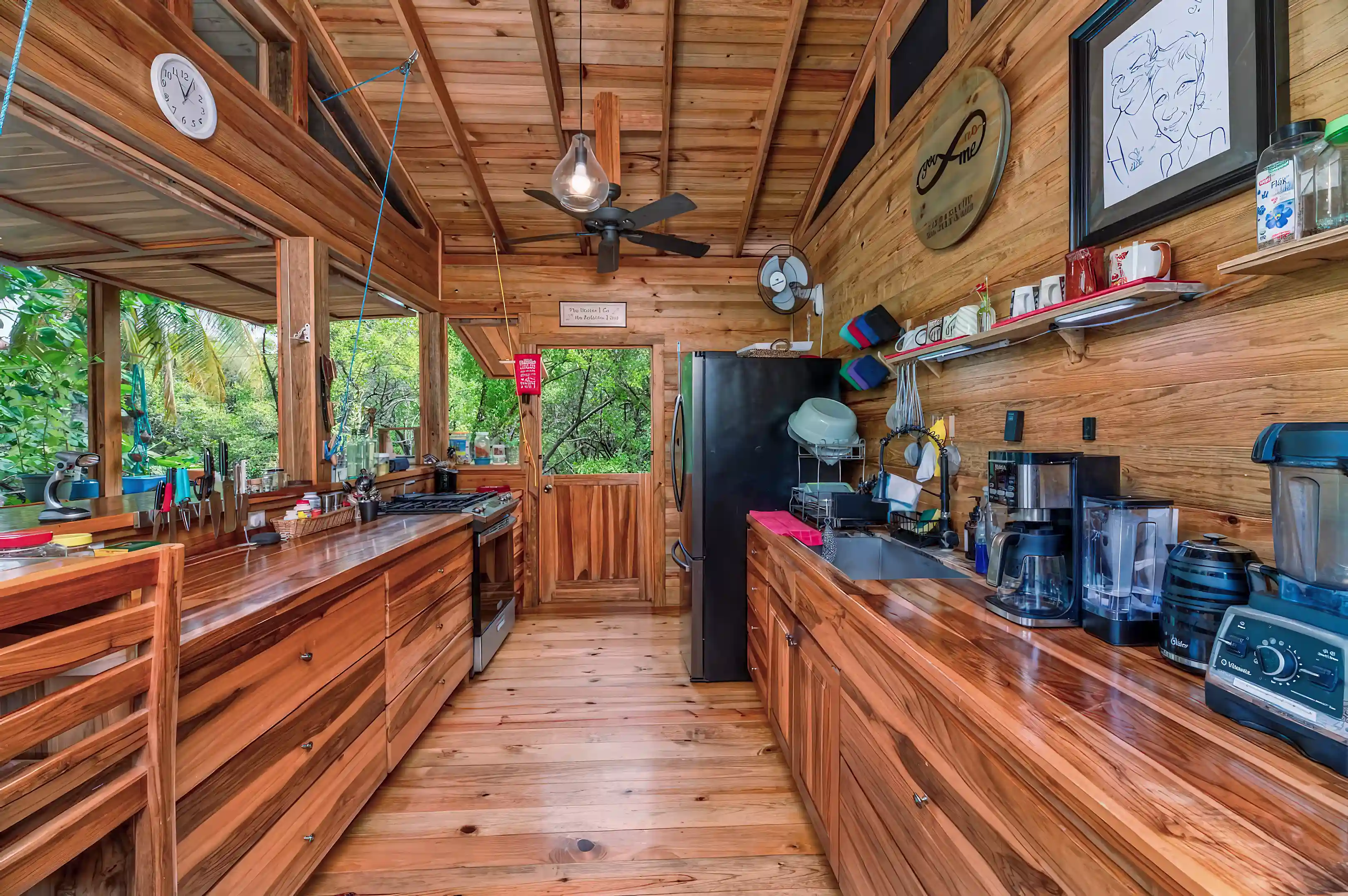 Kitchen design. Black appliances, ceiling fans, and screened gable ends...