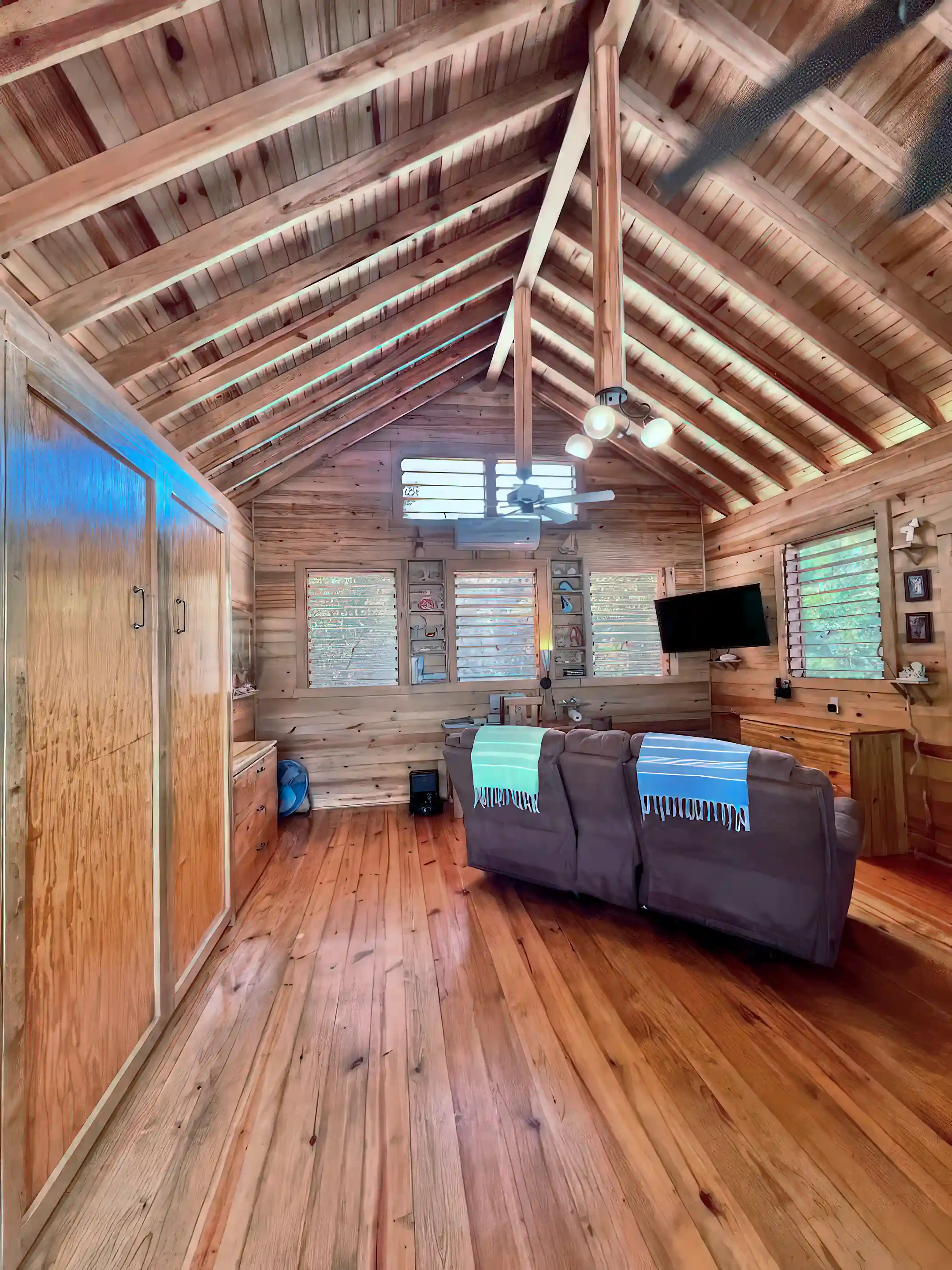 Living Room, or "Hangout". Open ceiling, screened and louvered gable...