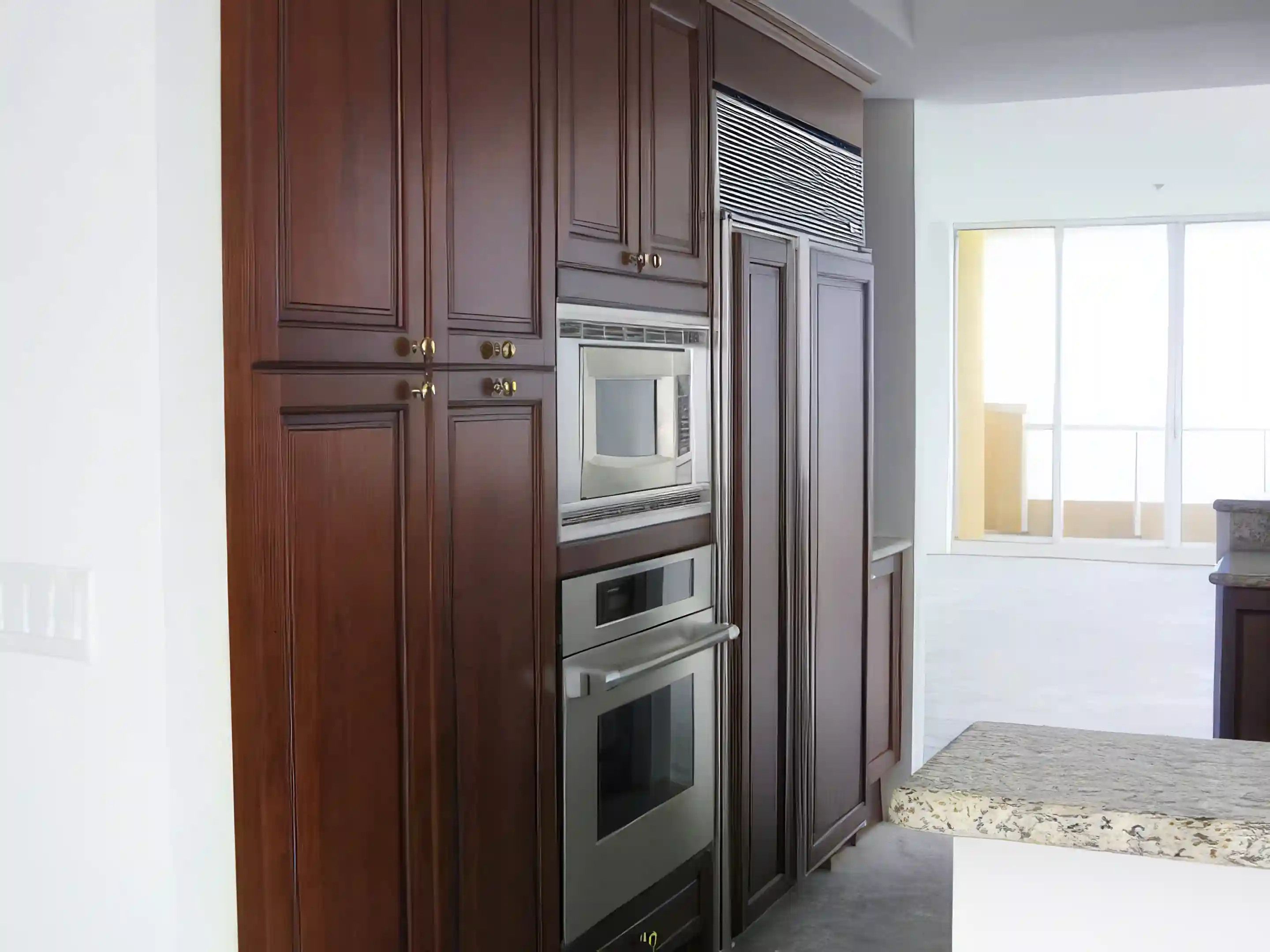 Kitchen refrigerator, microwave, oven, wood cabinets